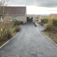 Tarmac is very cost effective for large areas like this. it looks good too, and it's long lasting, 15 - 20 years at least Tarmac driveway into Edinburgh bungalow