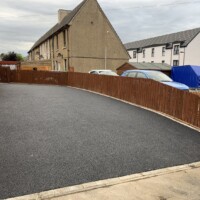 Smooth smart & practical tarmacadam driveways, this one's in Tranent EH32 & they're ideal for the harsh winter weather common in Scotland Tar paved residential driveway construction in Tranent Scotland